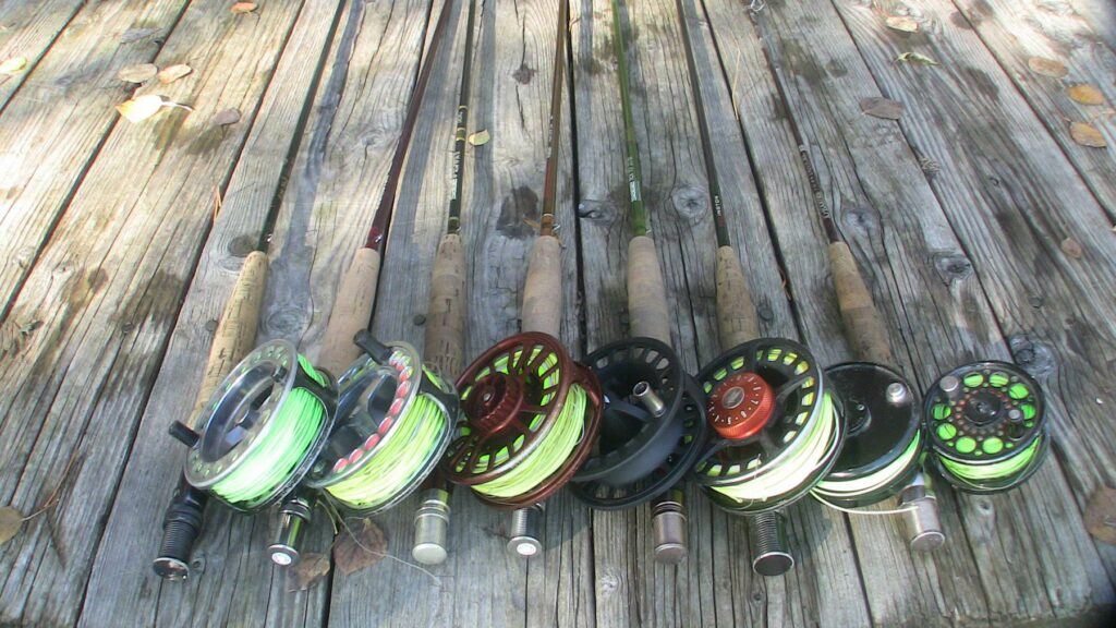 File:Fly fishing rods.JPG - a group of skates are lined up on a wooden deck