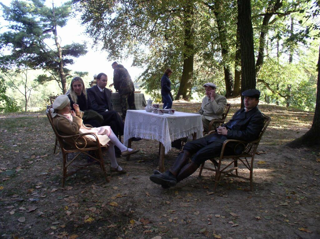 Belarus-Minsk-Loshytsa-Making Movie about Civil War-10 - a group of people sitting around a table