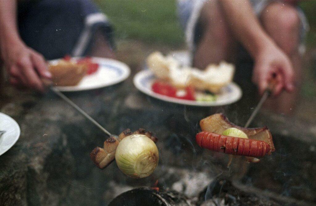 Hungarian barbecue feast, food photo - a couple of people sitting around a campfire